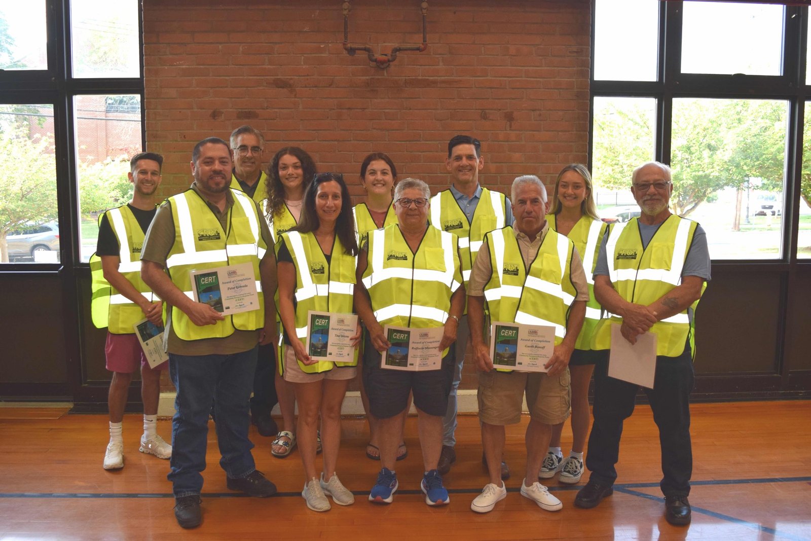 North Haven CERT volunteers wearing safety vests and holding training certificates