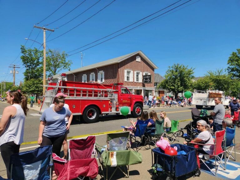 A Fire Engine Passing the Parade Crowd